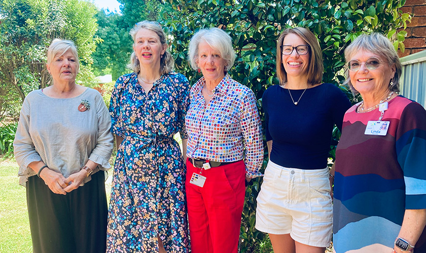 a group of five people standing together a group of five people standing together