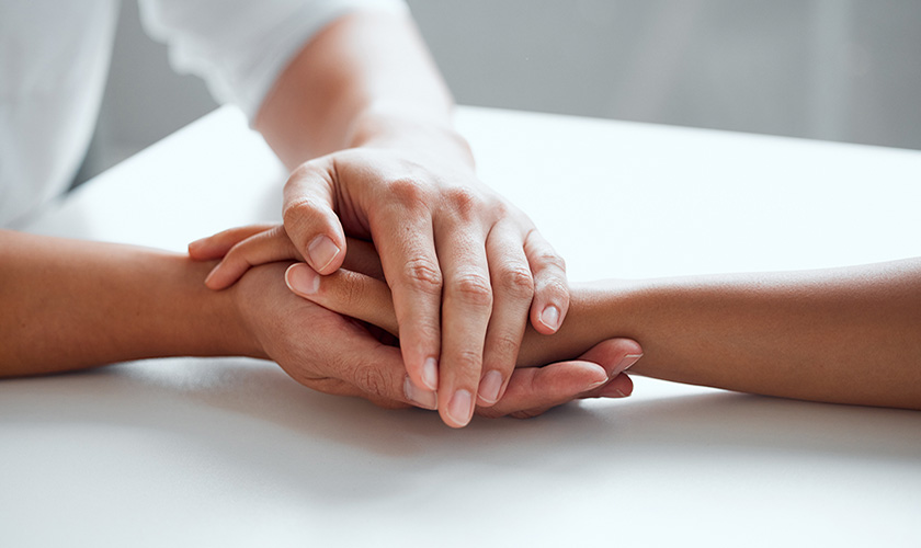 carer holding hands with a persons hands